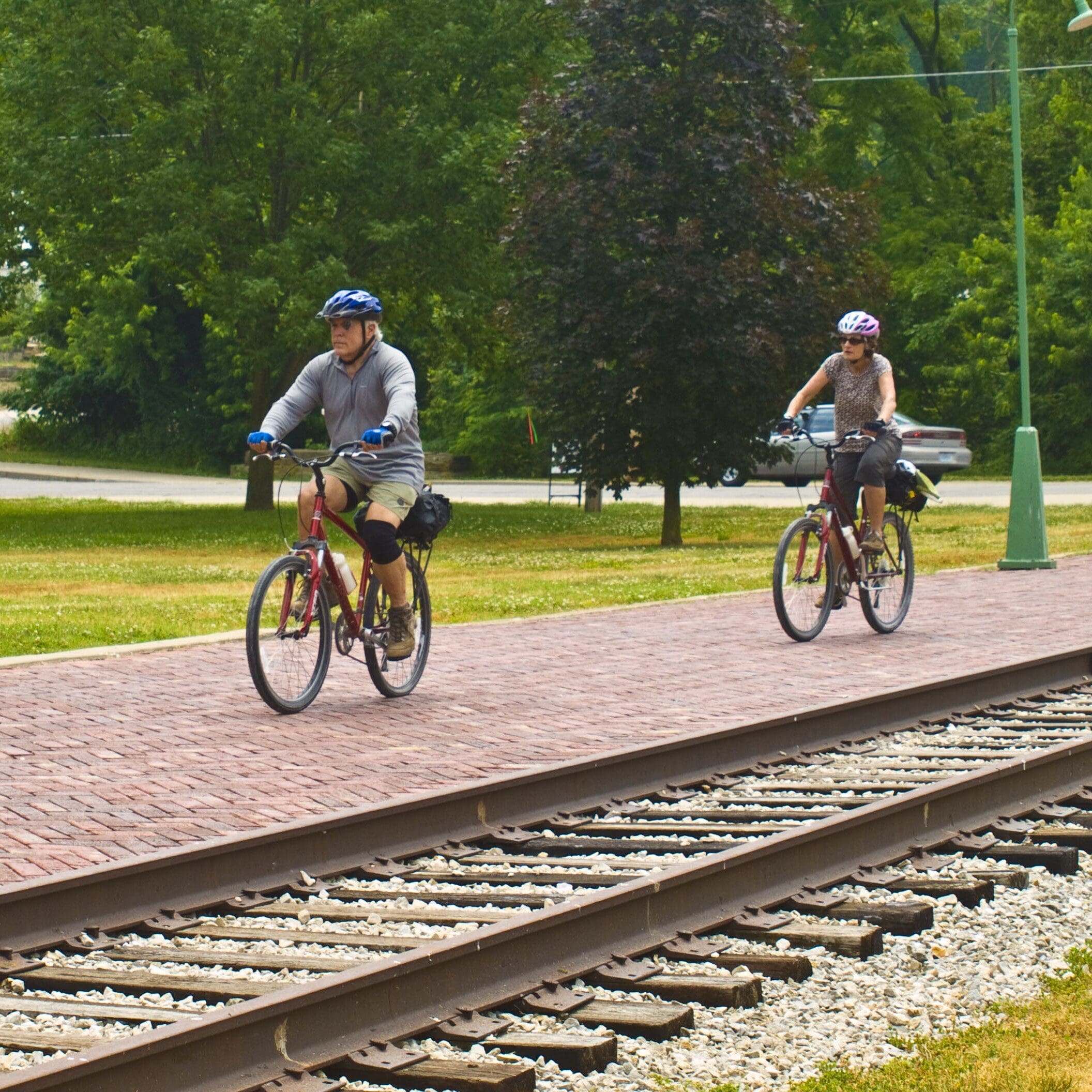 Cyclists riding along train tracks